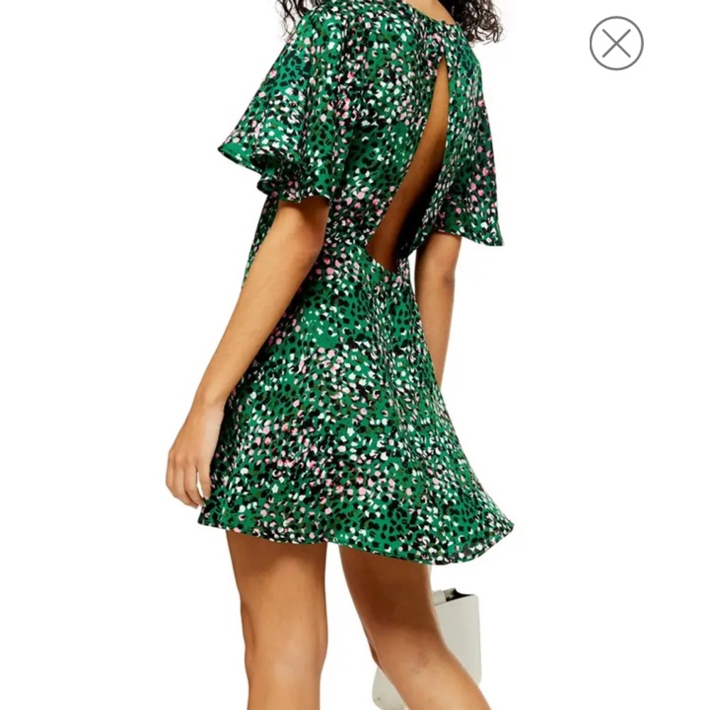 NWT! Chic emerald mini dress, fitted comfort with an alluring open back.
